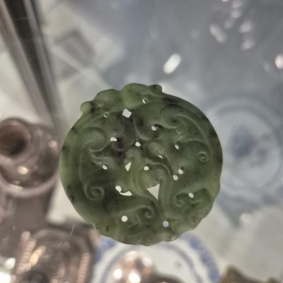 Lot 247 - Three Chinese pierced roundel pendants in jade...