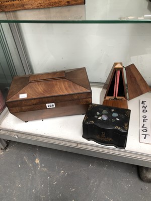 Lot 228 - Two 19th-century tea caddies and a metronome.