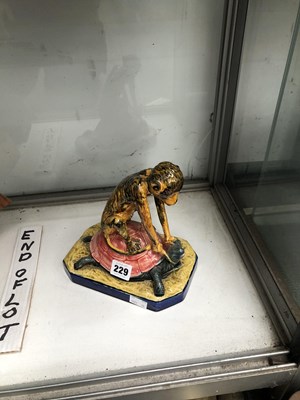 Lot 229 - A Majolica figure of a primate riding a turtle.