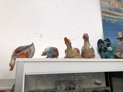 Lot 309 - A ceramic piggy bank and four duck figures.