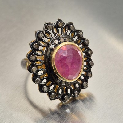 Lot 18 - A ruby and diamond dress ring. The central...