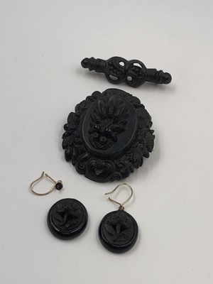 Lot 22 - Three pieces of carved mourning jewellery. A...