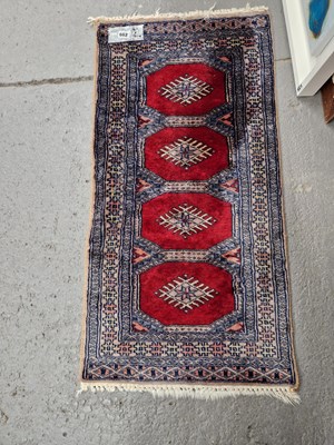 Lot 662 - An Oriental mat of Bokhara design