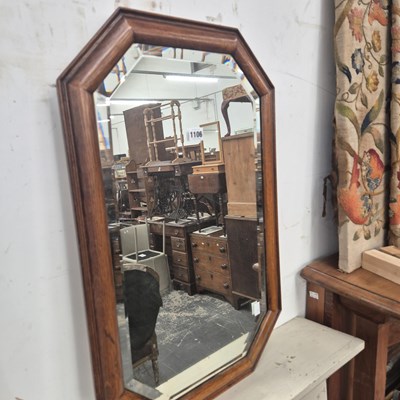 Lot 1106 - A bevelled glass mirror in a canted...