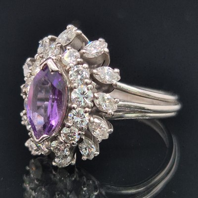 Lot 98 - An amethyst and diamond cluster ring. The...