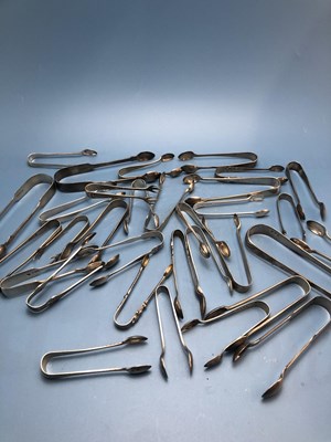 Lot 125 - Thirty three hallmarked silver sugar tongs,...