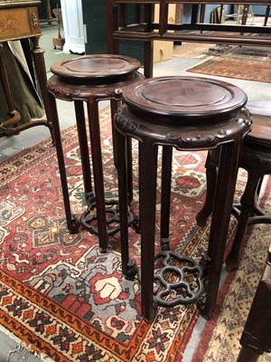 Lot 128 - A pair of Chinese hardwood urn stands. 31 cm...
