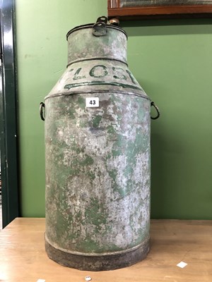 Lot 43 - A two handled milk churn and cover