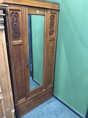 Lot 52 - A pine wardrobe, the mirrored door over a long...