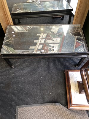 Lot 55 - An ebonised coffee table with the top carved...
