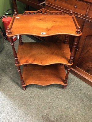Lot 62 - A mahogany whatnot with three serpentine...