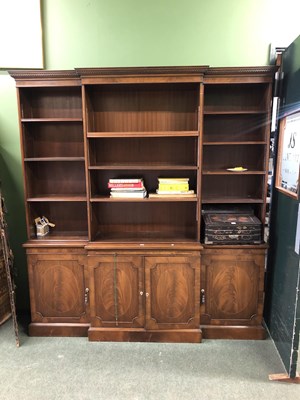 Lot 70 - A mahogany breakfront bookcase, the base with...