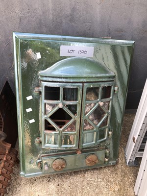 Lot 1320 - An enamel-finished iron solid fuel heater