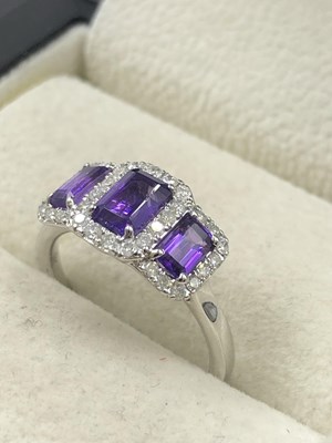 Lot 535b - A 9ct white gold triple cluster dress ring set...