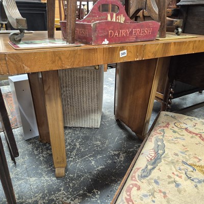Lot 305 - An art deco style walnut extending dining...