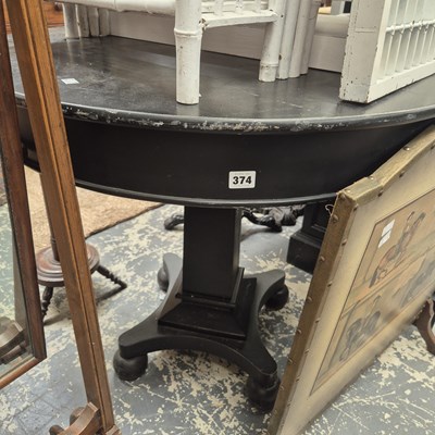 Lot 374 - An ebonised center table