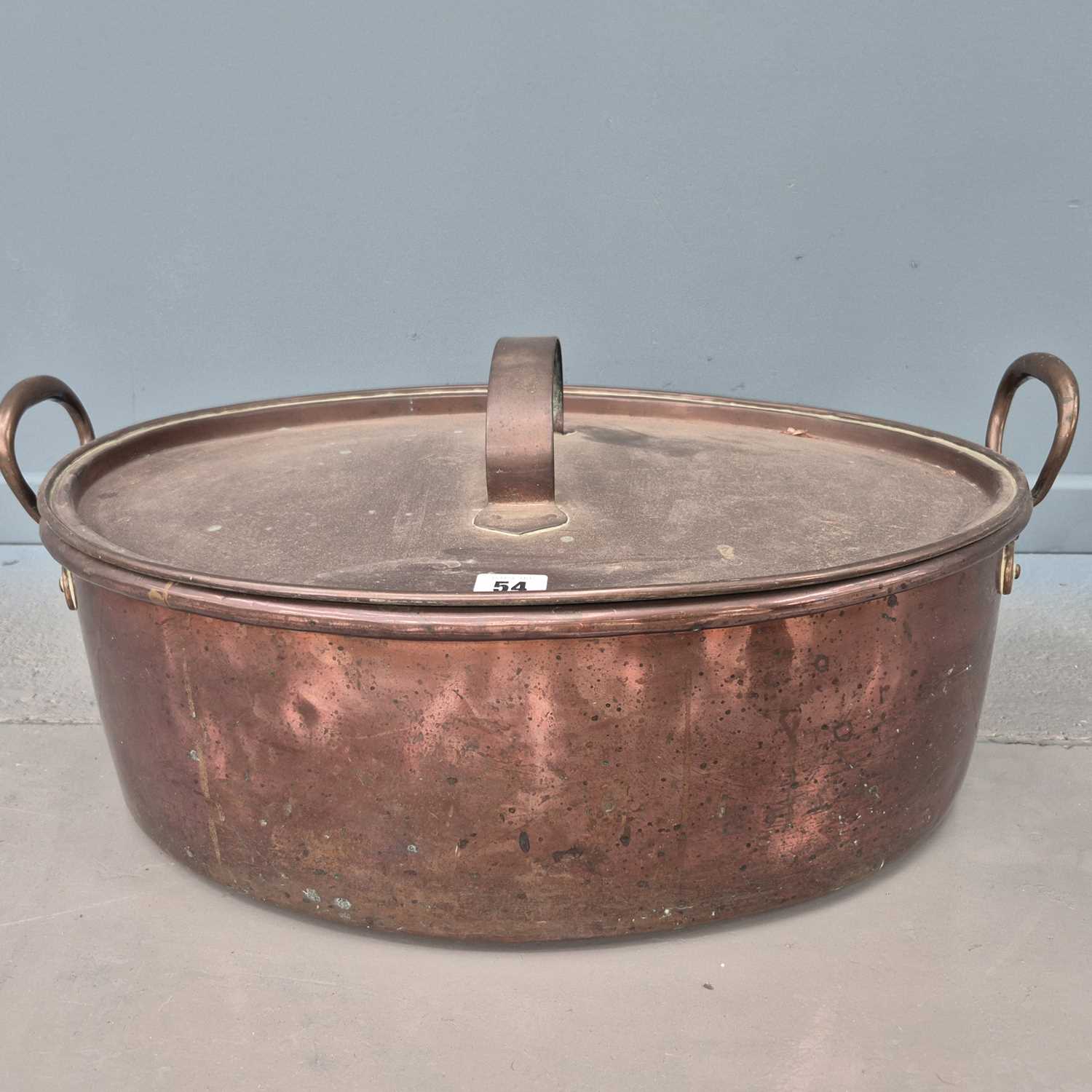 Lot 54 - An antique large copper oval fish kettle with...