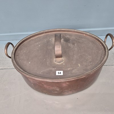 Lot 54 - An antique large copper oval fish kettle with...