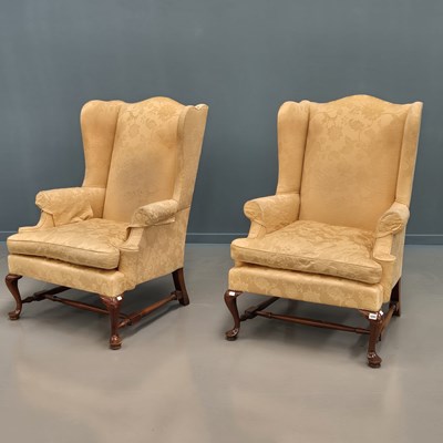 Lot 1695 - A pair of mahogany wing armchairs, the...