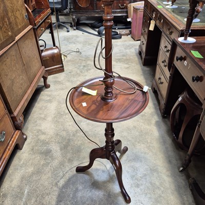 Lot 83 - A mahogany table lamp with a wine table tier.
