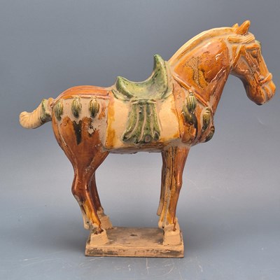 Lot 880 - A leather mounted saddled horse.   H 28cms....