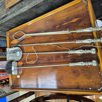 Lot 245 - A fire side companion set
