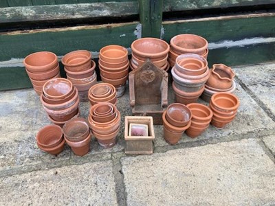 Lot 406 - A large collection of terracotta planters,...