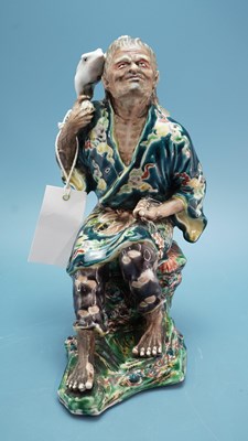 Lot 1331 - An early 20th century green Kutani figure of...