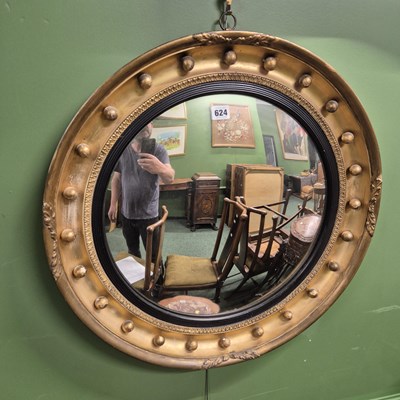 Lot 624 - A 19th century convex circular mirror within a...