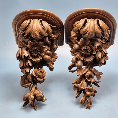 Lot 345 - A pair of rococo style carved wall brackets,...