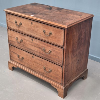 Lot 730 - A late Georgian mahogany chest of three long...