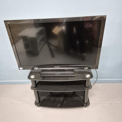 Lot 735 - A Panasonic Viera flat screen TV with a glass...