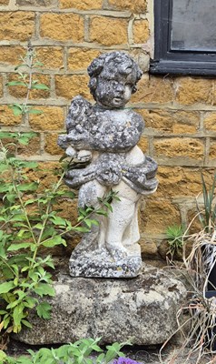 Lot 285 - A weathered garden figure of a standing putto,...