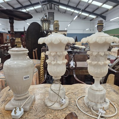 Lot 1015 - A pair of alabaster table lamps. Height to top...
