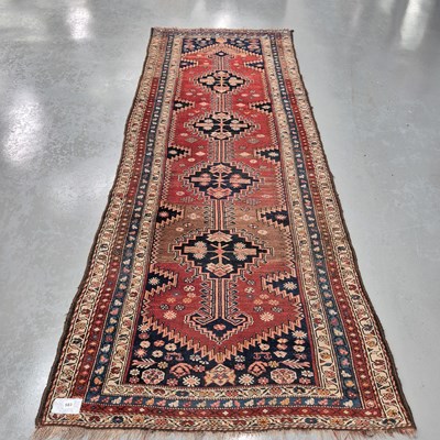 Lot 583 - An antique Persian tribal runner, L 308 W 115cms