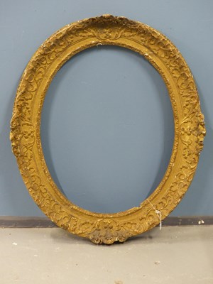Lot 1205 - An 18th-century carved oval giltwood frame,...