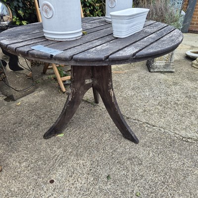 Lot 1127 - A heavy teak garden table.