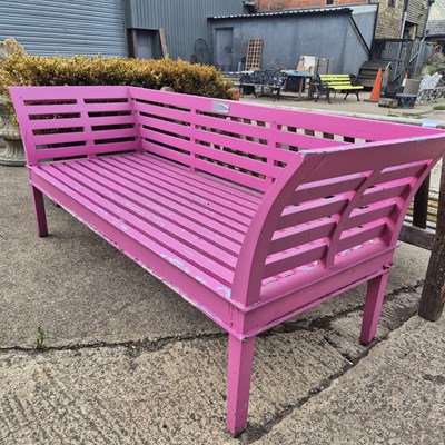 Lot 1129 - A vintage teak garden bench , later painted pink.