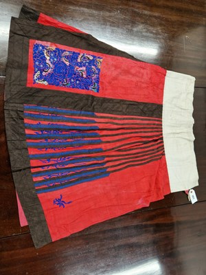 Lot 307 - A Chinese red silk skirt decorated with back...