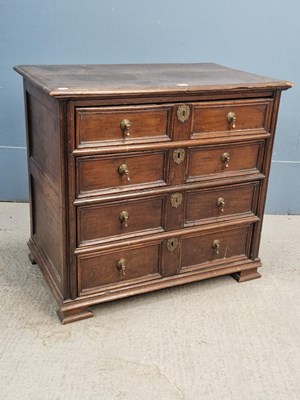 Lot 317 - An 18th century oak chest of four graded long...