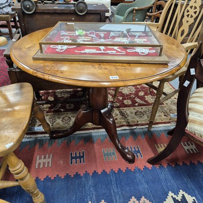 Lot 919 - A linnel yew wood tripod occasional table.