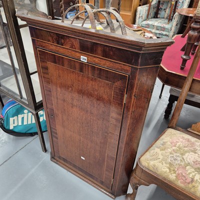 Lot 1206 - An early 19th-century mahogany corner cabinet