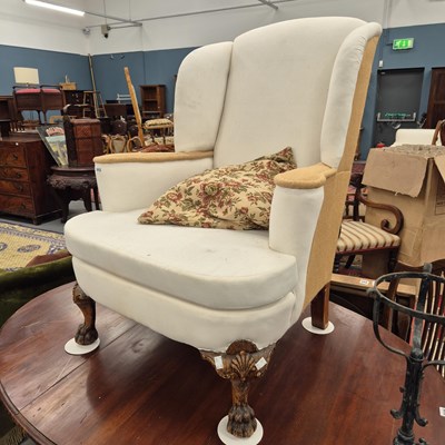 Lot 1012 - A recently upholstered wing armchair