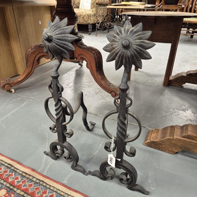 Lot 1047 - A pair of wrought iron fire dogs