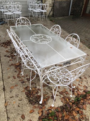 Lot 635 - A large garden glass-topped wrought iron table,...