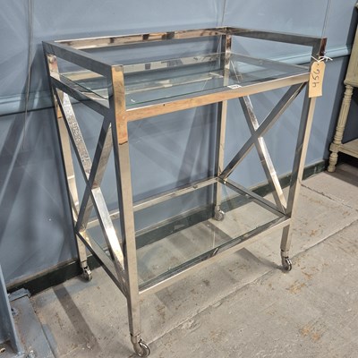 Lot 622 - A chrome and glass two tier trolley. H 81 W 65...