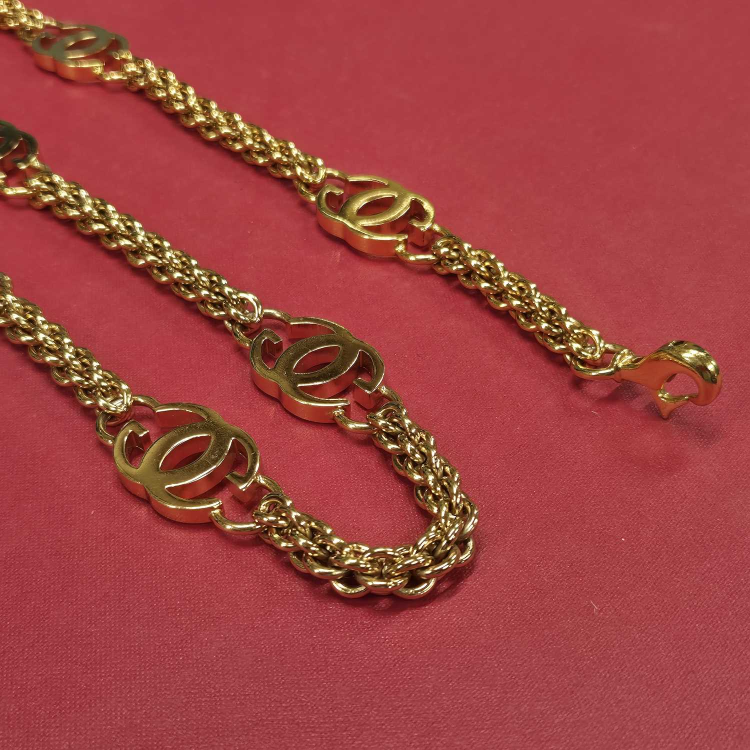 Lot 141 - Gucci- a vintage gold-plated logo chain belt.
