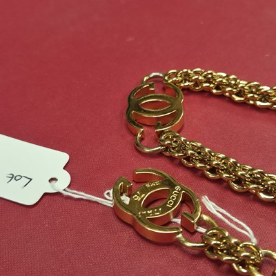Lot 141 - Gucci- a vintage gold-plated logo chain belt.