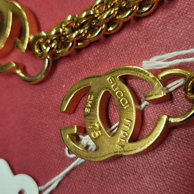 Lot 141 - Gucci- a vintage gold-plated logo chain belt.