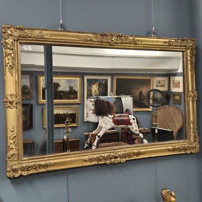 Lot 653 - A Victorian gilt-framed wall mirror.